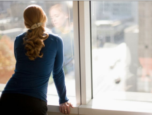 woman looking out window